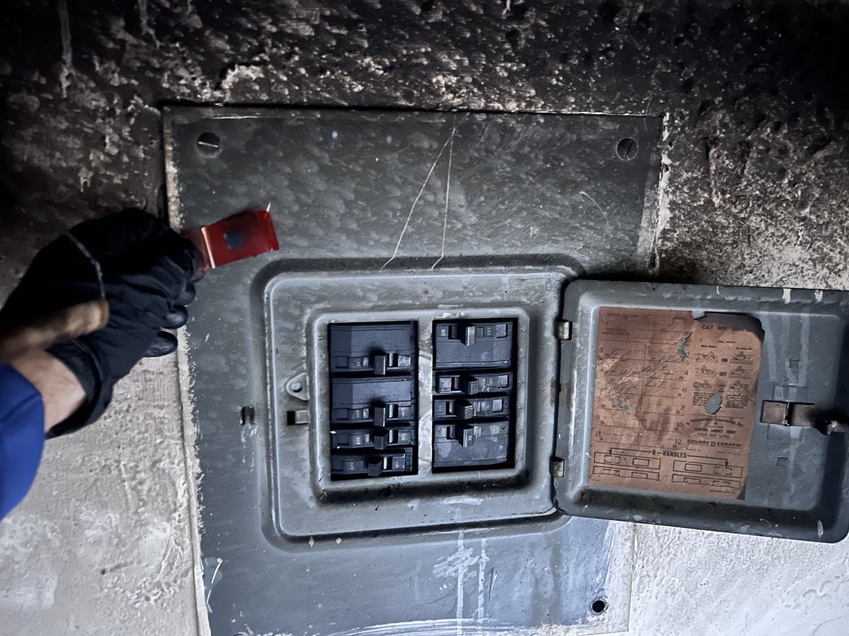 Burned electrical panel being sampled